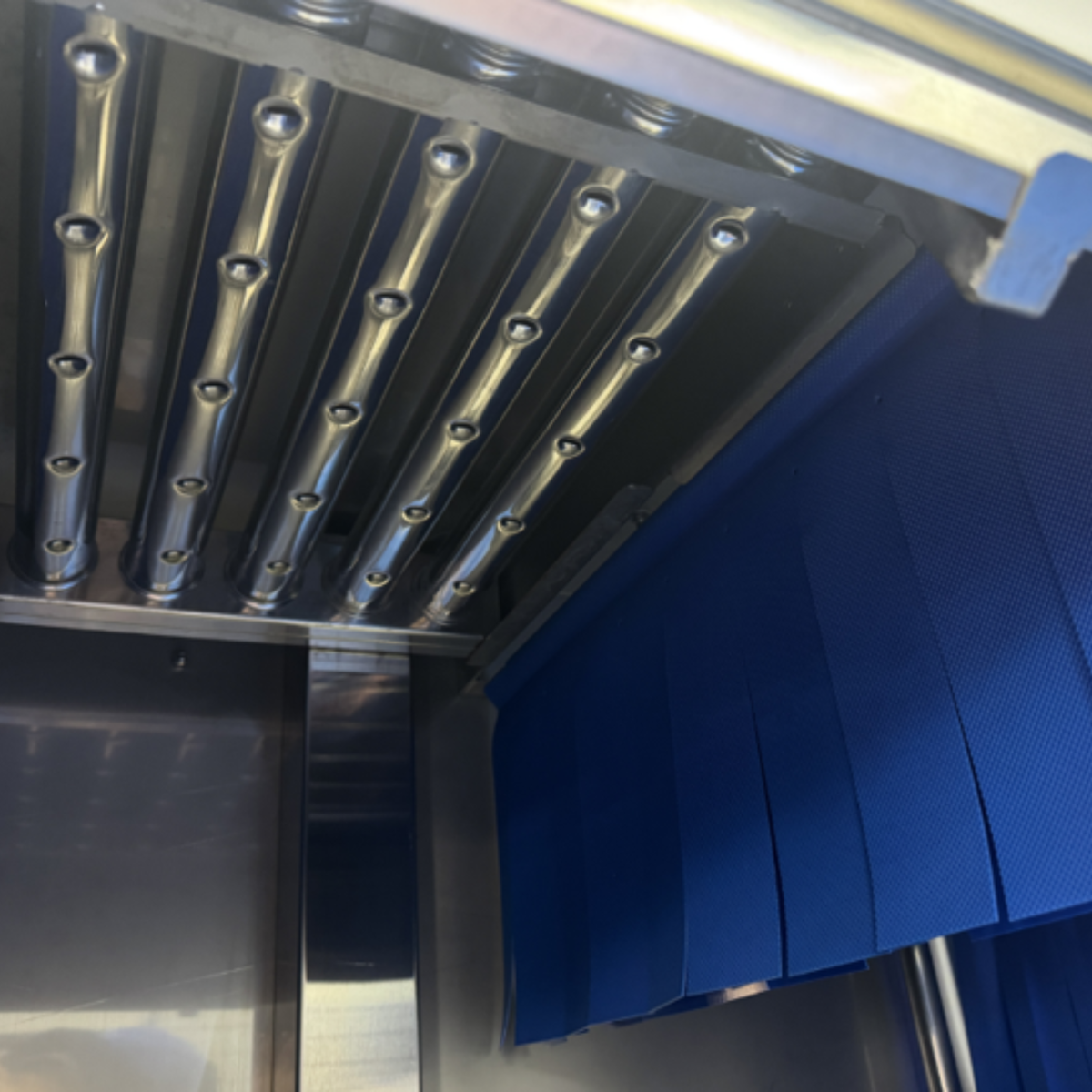 Interior wash chamber of the 200C Series commercial conveyor dishwasher
